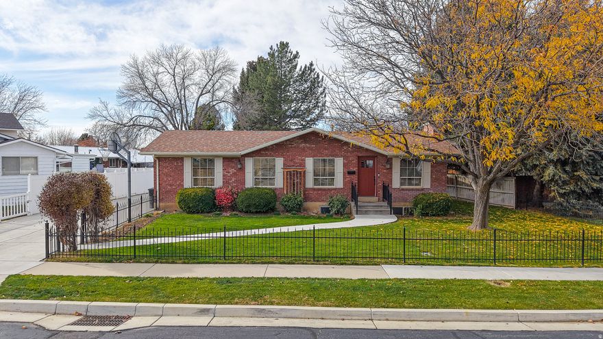 *Make sure to click on "tours" to view 3D tour*  Exceptionally maintained and full of charm, this brick home in the heart of Spanish Fork offers both comfort and character. The well-kept 5-bed, 3-bath layout includes spacious living areas, abundant storage, a large laundry room, two fireplaces, beautiful hardwood flooring, and timeless finishes throughout.  The outdoor space is where this property truly stands out-featuring a large detached garage, dedicated workshop, and an additional storage shed, perfect for hobbies, equipment, and projects. Mature, manicured landscaping surrounds an expansive covered patio, creating an ideal setting for peaceful relaxation or lively gatherings.  Experience charming curb appeal and comfort both inside and out.