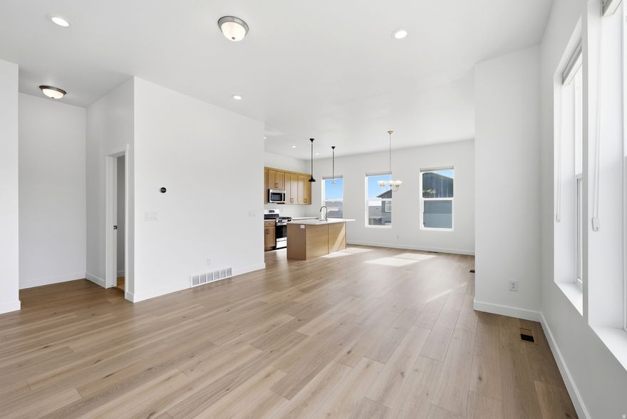 Welcome to this stunning row-end townhome, built in 2022 and offering 2,140 square feet of thoughtfully designed living space with high ceilings and contemporary finishes throughout. The main level features an open great room, an informal dining area, a pantry closet and stainless steel appliances, perfect for everyday living and entertaining. Step out onto the walkout balcony from the additional living area, or unwind on the charming front porch with friends and family. A convenient powder room on the main level, two-car garage and great storage throughout, including under the stairs, and round out the main level beautifully. For those looking to personalize, an unfinished bedroom or office and bathroom on the first floor offer a blank canvas to make your own.  Upstairs, all three bedrooms are conveniently located on the same floor, including a serene owner's ensuite complete with a walk-in closet and a private balcony, your own peaceful retreat. Two full bathrooms serve the upper level, and the washer and dryer hookup adds everyday convenience. Stay comfortable year-round with central AC, forced air heating, a tankless water heater, and an air purifier system for cleaner indoor air quality. Outside, enjoy a quiet neighborhood setting with a community park right across the street. This exceptional home is truly move-in ready and built to create lasting memories for years to come.