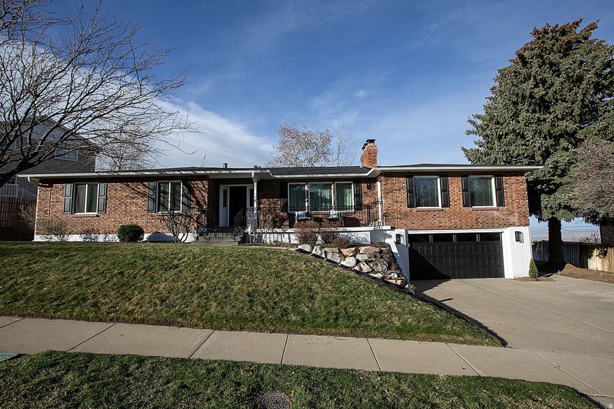 Perched high on the desirable Bountiful Bench, this beautifully updated single-family   home offers comfort, style, and peace of mind with numerous recent upgrades. The home features a brand-new roof along with new fascia, soffit, and rain gutters providing both durability and curb appeal. New vinyl windows throughout bring in abundant natural light while improving energy efficiency. The updated chef's kitchen is the heart of the home, featuring custom white cabinets, stainless steel appliances, sleek granite countertops, and beautiful hardwood flooring that extends through the kitchen, dining area and entryway. Fresh paint and brand-new carpet throughout give the entire home a clean, modern feel.  Designed for both everyday living and entertaining, the home includes three large gathering spaces, providing plenty of room for family and guests. Bathrooms have been newly updated with stylish finishes and the main floor includes a dedicated study-perfect for working from home. The lower level is set up perfectly for family use, mother-in-law apartment or ADU, offering flexibility for families with kids, multi-generational living or potential rental income. Outside, a new vinyl fence is currently being installed in the backyard, adding privacy and completing the outdoor space. With its elevated location on Bountiful Bench, thoughtful updates, and versatile layout, this home offers exceptional comfort and opportunity in a highly sought-after neighborhood.