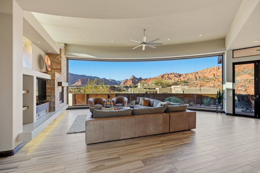 Elevated in the Cliffs of Snow Canyon, this exceptional home offers a front-row seat to one of Southern Utah's most iconic landscapes. Floor-to-ceiling butted glass captures sweeping canyon views while filling the home with natural light and seamlessly blending indoor and outdoor living. The custom designed layout features 3 bedrooms plus a private office, highlighted by high-end finishes and generous spaces ideal for entertaining. The thoughtfullydesigned kitchen is both striking and functional, showcasing premium appliances, sleek cabinetry, and abundant storage for effortless everyday living and hosting. The primary suite serves as a private sanctuary with stunning views and a spa-inspired outdoor shower. Multiple outdoor fire pits extend the living space and set the stage for sunset gatherings and starlit evenings overlooking Snow Canyon.