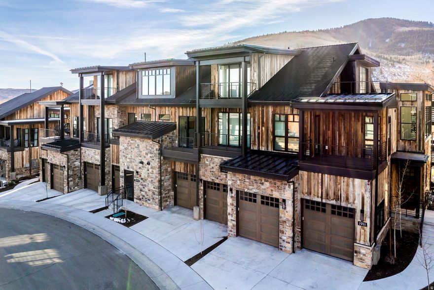 Experience elevated mountain living in this impeccably maintained modern ski residence, ideally located in Canyons Village at Park City Mountain Resort. Positioned for effortless access to world-class skiing, hiking, golf, and mountain biking, this home perfectly balances year-round recreation with refined luxury.  Designed for contemporary mountain lifestyles, the residence showcases 1011 foot ceilings, expansive glass walls, and a south-facing orientation that frames sweeping, uninterrupted mountain views. Sun-drenched living spaces flow seamlessly into a chef's kitchen outfitted with Sub-Zero and Wolf appliances, a generous walk-in pantry, and reverse osmosis with insta-hot filtration-crafted for elevated entertaining and everyday ease.  The primary suite is a private sanctuary featuring heated floors, custom-built closets, and spa-level finishes. Throughout the home, custom millwork, sleek fixtures, and smart electric shades refine the experience of comfort and sophistication.  Thoughtful enhancements include a whole-home water softener, 240V EV charging, dedicated ski storage, and extensive built-in cabinetry for turnkey functionality.  With optional designer furnishings and exceptional proximity to the slopes, this property represents one of Park City's most compelling opportunities-a luxurious retreat, a high-performing rental investment, or an elegant primary home engineered for both lifestyle and longevity.  Discover refined mountain living where architectural excellence meets unmatched access to the Park City experience.