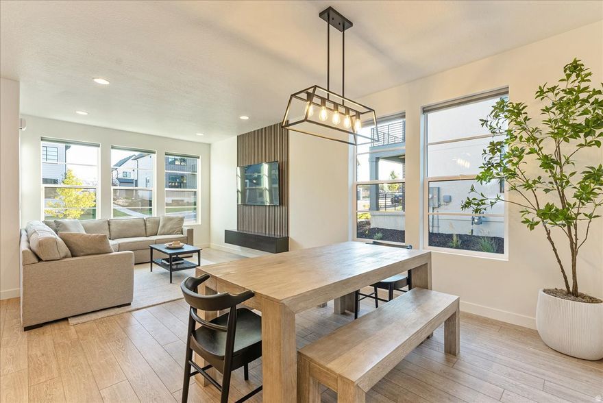Tucked in the heart of Lehi - recently named one of the best small cities to live in the U.S. This immaculate Scandinavian-style home blends modern design with everyday comfort. The minimalist aesthetic is paired with beautiful upgraded lighting and hardware, creating a space that feels both stylish and welcoming. Inside, you'll find three spacious bedrooms, a big loft, custom accent walls throughout  that add character, and an unfinished basement ready for your personal touch. The home also includes a water softener and epoxy garage flooring for durability and easy upkeep. You'll also appreciate the thoughtful upgrades throughout, including high-end custom blinds that elevate both style and privacy. The kitchen and laundry are move-in ready with a refrigerator, washer, and dryer, all purchased in 2024, adding convenience and value from day one. Location is a major highlight, you're just minutes from Traverse Mountain with its shopping and outlets, and about the same distance to Costco and Harmons Grocery. A new Smith's Food and Drug is also currently being built just a couple of minutes away, adding even more convenience. Commuting is easy with quick access to Mountain View Corridor (SR-85) just moments from the home, offering a direct route toward Salt Lake City. You're also about 10 minutes from Interstate 15 (Veterans Memorial Highway), making travel north to Salt Lake or south toward Las Vegas simple and convenient. Even better, the HOA takes care of landscaping and snow removal, making maintenance simple year-round. Homeowners in the Ivory Scandinavian community also enjoy access to a private clubhouse and pool, perfect for relaxing and connecting with neighbors. If you're looking for a modern home with clean design and low-maintenance living, this one is truly special.