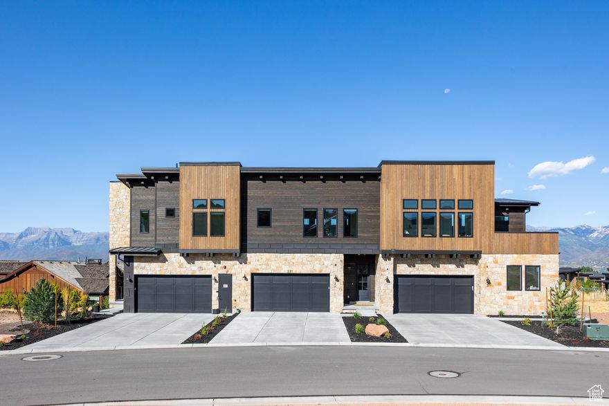 Experience effortless mountain living in this beautifully designed townhome in the heart of the Red Ledges community. Built by Hillwood Homes in 2025, this lightly lived-in residence offers thoughtful design with quality craftsmanship. Abundant windows and an expansive slider frame sweeping views of the Wasatch Back, creating a seamless flow between indoor and outdoor living.  This home is move-in ready with high-end finishes throughout, including Thermador appliances, upgraded electrical, and designer furnishings included in the sale. The two-car garage offers ample storage along with a 220-volt outlet - ideal for EV charging or workshop use.  Perfectly situated within walking distance to the Jack Nicklaus Signature 12-hole Golf Park, the Village Center pool and restaurant, tennis and pickleball complexes, fitness center, and scenic trails, this townhome provides a rare combination of convenience, luxury, and low-maintenance living in Red Ledges.