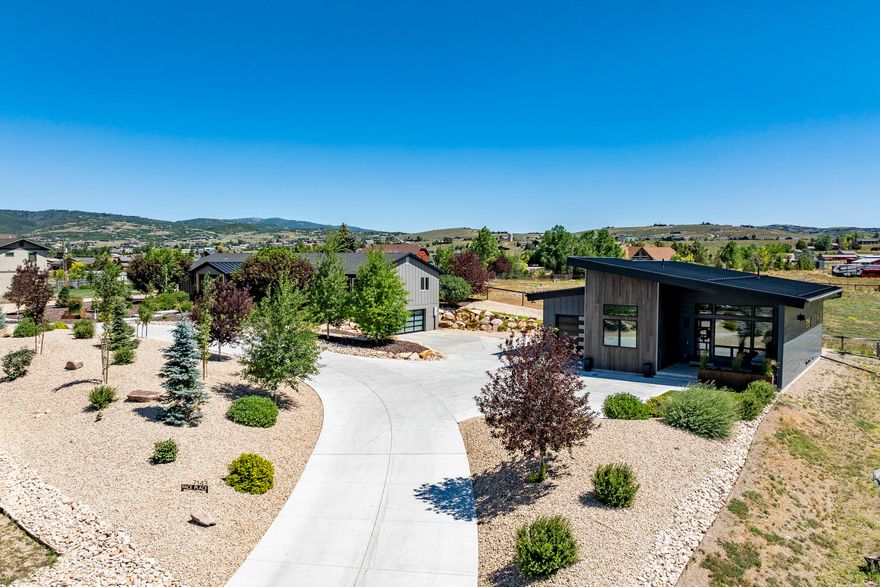 This stunning Silver Creek Estates property includes two breathtaking ready-to-move-in homes. The newly renovated main modern home offers a custom kitchen, 5 bedrooms, 3.5 baths, 2 laundry areas, and recently added windows, expanding the amazing mountain views of the Utah Olympic Park, Park City, and Deer Valley ski areas. Also, freshly painted, includes custom cabinetry, new furnace, AC, water heater, plumbing, electrical, metal roofing and exterior, and so much more. Larger two-car garage with an EV charger. The basement was recently completed with a stylish dry bar, linear fireplace, and plenty of storage. The second home is a gorgeous new custom modern, Scandinavian-inspired guest house with vaulted ceilings, 2 bedrooms, 2 full baths, a laundry area, full kitchen, stunning fireplace with metal surround, a loft, and an oversized, tandem garage with an EV charger. Use the guest house as additional living space or take advantage of great rental income while living in the main house, or vice versa. Both homes boast outstanding Park City mountain views and open space out back. This 0.93-acre property is fully landscaped with xeriscaping and is on the new city sewer system. It is honestly hard to find a property that has been more meticulously maintained than this incredible home. Located just 30 minutes from Salt Lake International Airport, 10 minutes from world-class skiing, and only a quick 15-minute drive to the renowned shops, restaurants, and events of Park City's Main Street. It is also located within the Park City School District boundaries. Walk right in and begin living the ultimate Park City lifestyle now!