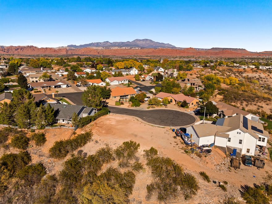 Attention: Specialized Lot with Significant Geotechnical Challenges - Engineering Review Required. This lot is priced to reflect documented slope stability issues that may prevent conventional residential development. Two geotechnical engineering reports (2002 AGEC, 2018 Landmark) are available and MUST be reviewed by prospective buyers. The 2018 analysis indicates the slope does not meet minimum safety factors and may not support standard residential construction even with mitigation. Buyers must retain their own geotechnical engineer to verify IF and HOW this lot can be developed prior to closing. Property sold AS-IS. That said - stunning unobstructed views of mountains, knolls, green Santa Clara River valley farmlands, and historic Jacob Hamblin Home. Cul-de-sac location near Santa Clara Elementary. Potential opportunity for creative buyer willing to explore specialized engineering solutions. Both reports available for immediate review. Buyer must independently verify all information and buildability.