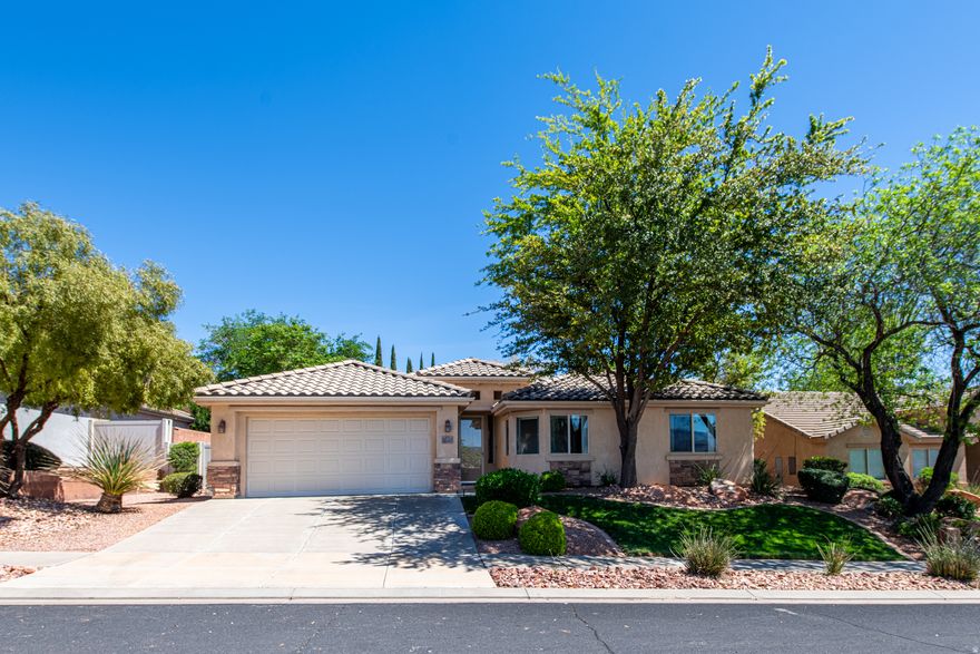 Welcome to this Beautiful 4-bedroom, 2-bath, move-in ready home with scenic views of Red Mountain and the West Mountains of St. George! This single-level home offers vaulted ceilings, solar tubes, and a bright, open floor plan filled with natural light. The kitchen features stainless steel appliances, a brand-new refrigerator, abundant cabinet space, and generous counter space for everyday living and entertaining. The spacious primary suite includes dual sinks, two walk-in closets, a soaking tub, and a separate shower. Relax under the covered patio in the backyard with natural desert xeriscaping, and a tall lava rock wall for added privacy. Conveniently located just minutes from schools, parks, Snow Canyon State Park, hiking, and biking trails. Don't miss the opportunity to make this well-maintained Southern Utah home your own!