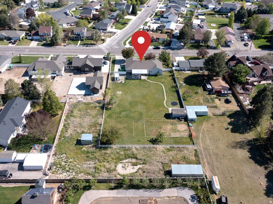 Rare rambler in prime Highland location with animal rights! 6 bedrooms 3.5 bathrooms,2 car garage with flex space and oversized driveway!RV access, separate entrance to the basement where you'll find an additional kitchen and laundry hookup,great in law quarters! Massive .86 Acre lot with lots of potential! Covered patio with mechanical covering,enjoy the sun or the shade! 3 Large animals and 12 small animals per Highland city zoning, buyer to verify all details including square footage and zoning.