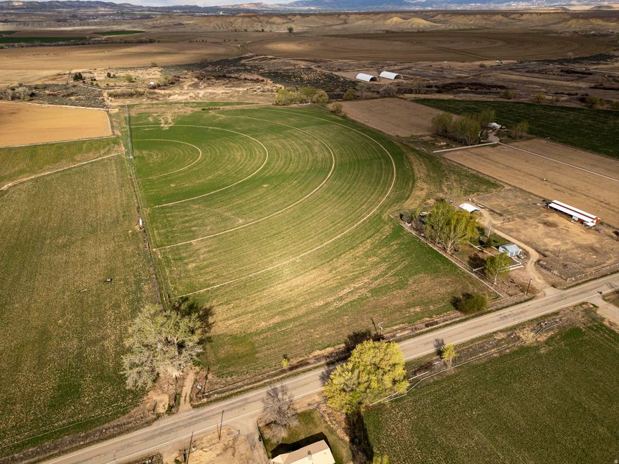 45-Acre Farm Opportunity in Jensen, Utah  Abundant Water Rights & Breathtaking Split Mountain Views Nestled in the scenic high desert of Jensen, Utah, this expansive 45-acre farm offers a true slice of rural paradise with unparalleled potential for agriculture, ranching, recreation, or your custom dream estate. Located in historic Uintah County near Dinosaur National Monument, the property boasts commanding, unobstructed views of iconic Split Mountain The land features a mix of open pastures, tillable ground, and natural terrain ideal for hay production, livestock grazing, or equestrian use.  Water security sets this property apart. It includes 6 shares of Primary Burns Bench Irrigation Company water, providing reliable access to high-quality irrigation from the Jensen Unit system. Additionally, 92 shares of J Stock deliver versatile water rights that enhance flexibility for farming, stock watering, or supplemental needs. There is also a culinary Jensen water hook up located in the south west corner of the property.
