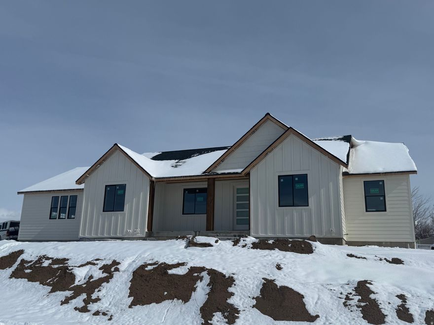 Custom kitchen, finished garage, on demand hot water heater, flexible basement designed for accessory luxury income rental 20% finished, LP siding all the way through. High efficiency furnace & high efficiency insulation. Extra storage, 3 car garage, piped for wood burner in the basement. Radon prepped. City services with country views. Welcome to your new home! This beautiful property offers timeless charm with modern comfort, featuring spacious living areas, abundant natural light, and thoughtful finishes throughout. Designed for both everyday living and entertaining, it combines style, functionality, and a warm inviting atmosphere. Other lots available to be built by Silver Spurs Construction LLC.  View of room layout for future possibilities in basement, theater, accessory apartment, adjust doorway to make 4 bedrooms accessible to upstairs with accessory apartment downstairs etc. Main level living and views of sunset skies. Come see this warm home.