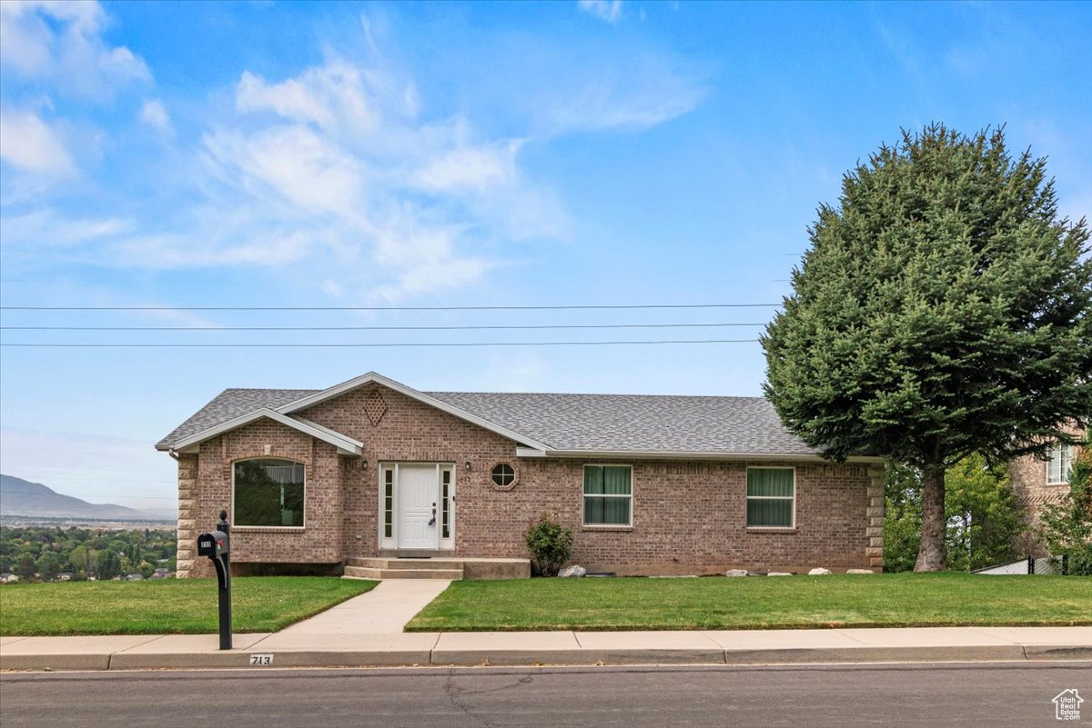Stop what you're doing and check out this completely updated rambler that's as charming as it is spacious! This house has the kitchen of your dreams with a huge granite island and matching wraparound granite counter tops. The kitchen and adjacent semi-formal dining room feature a beautiful, high-end wood floor--that's real wood, mind you. With fresh paint and brand-new carpet (everywhere), your main floor opens out to a huge deck with unbelievable views of the entire valley. July 4th, 24th, and New Year's Day is a sight to behold, let alone the sunset every single night. Did we mention this house is brick all the way around? This 5-bedroom, 3-bath beauty has all the space you could need-and then some. Let's not forget the views of the mountains to the East and the access to the Bonneville Shoreline Trail at the end of the street. You will be mere steps away from hiking, biking, making friends with Bambi and friends. The backyard offers you tons of room and potential for any project you can imagine. Don't miss out on this one or you'll find yourself stuck somewhere down in the valley with a nice view of your neighbor's vinyl siding instead of seeing the sunset reflect off Utah Lake.