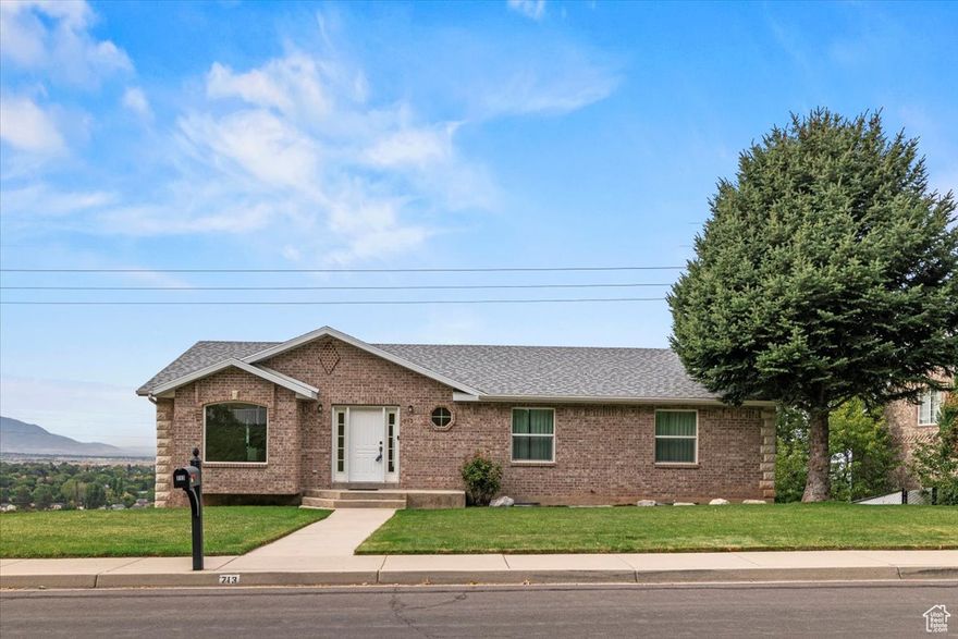 Stop what you're doing and check out this completely updated rambler that's as charming as it is spacious! This house has the kitchen of your dreams with a huge granite island and matching wraparound granite counter tops. The kitchen and adjacent semi-formal dining room feature a beautiful, high-end wood floor--that's real wood, mind you. With fresh paint and brand-new carpet (everywhere), your main floor opens out to a huge deck with unbelievable views of the entire valley. July 4th, 24th, and New Year's Day is a sight to behold, let alone the sunset every single night. Did we mention this house is brick all the way around? This 5-bedroom, 3-bath beauty has all the space you could need-and then some. Let's not forget the views of the mountains to the East and the access to the Bonneville Shoreline Trail at the end of the street. You will be mere steps away from hiking, biking, making friends with Bambi and friends. The backyard offers you tons of room and potential for any project you can imagine. Don't miss out on this one or you'll find yourself stuck somewhere down in the valley with a nice view of your neighbor's vinyl siding instead of seeing the sunset reflect off Utah Lake.