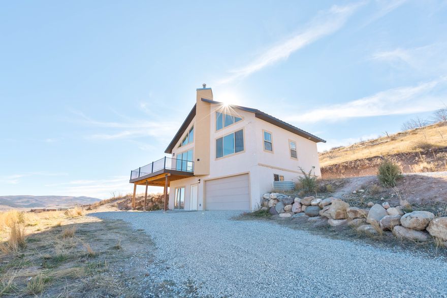 Don't miss this off-grid homesteader's paradise, eligible for financing as a primary or secondary home! This fully permitted, move-in-ready home boasts breathtaking, year-round mountain views that inspire. Current owners offered this home months ago as a shell but decided to finish it for you according to code. Designed with natural materials and earthy tones, it blends modern comforts with rustic charm. The spacious primary suite features a soaking tub, tile shower, and walk-in closet. Enjoy the wraparound Trex deck, perfect for meals, coffee, and soaking in the vistas. The open floor plan is ideal for gatherings. The basement is ready for use as a family room, game room, or extra bedroom. With thermostatic gas heat, solar power, and a whole-house generator, this home ensures comfort and peace of mind year round. It's also plumbed for radiant floor heat and an additional basement bathroom when you're ready.