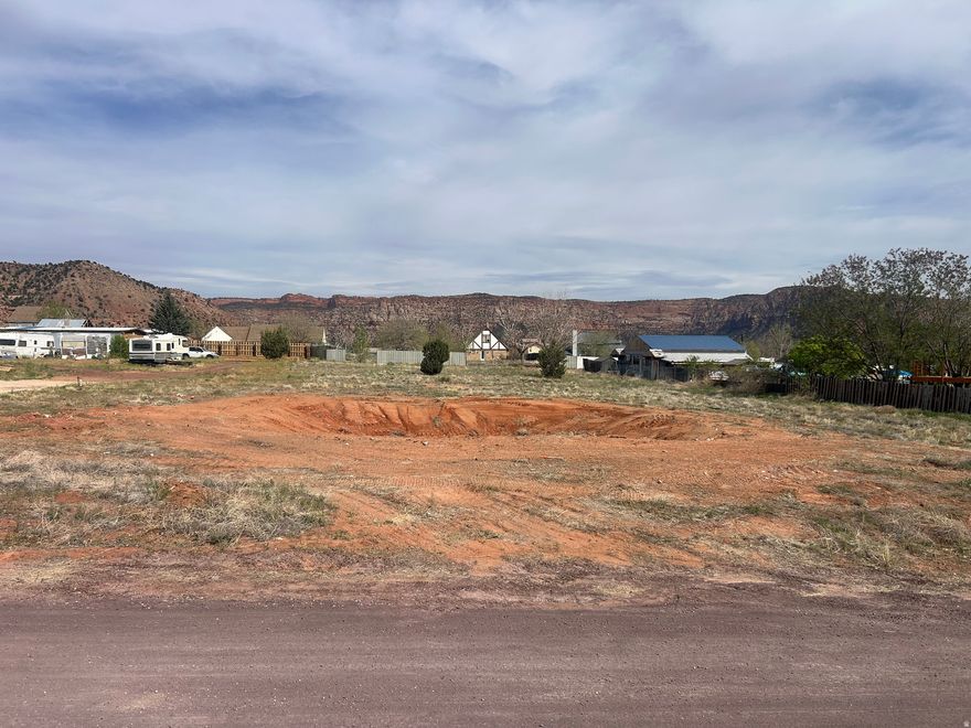 Foundation has been removed, Rare opportunity to own a flat 0.86-acre buildable lot with unobstructed red cliff views in a new and growing neighborhood. This ready-to-build lot offers natural privacy, a prime location, and easy access to utilities.  Water meter is installed, and water, sewer, and gas fees have been paid, saving buyers significant upfront costs. Most utilities are stubbed to the lot line, making this an ideal site for a custom home.  Seller is motivated and will consider any reasonable offer.