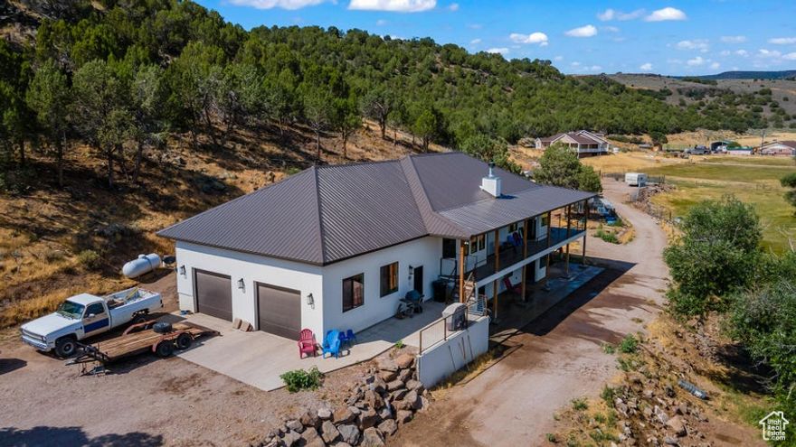 Beautiful mountainside mini ranch home on 10 acres. Enterprise, UT is a small rural farming town in Southern Utah. Only 40 minutes from St. George or Cedar City. Built in 2020 with 3,603sqft, 5 beds, 2.5 bath, large oversized 979 sqft 2 car garage, on 10.55 acres. Walkout basement. Open Floor Plan. Living room on main and family room in basement. Fireplace. Plenty of room for horses, animals, build a shop, barn, or stable. Enjoy coffee or cocoa on the deck. Nestled against the mountainside for privacy and with beautiful views all around. South property line backs to BLM land. Enterprise Reservoir is only 15 minutes away for fishing and boating. Lots of outdoor recreation. Close to restaurants, grocery, schools, medical, auto services, and hardware. Rural life with convenience. A must see.