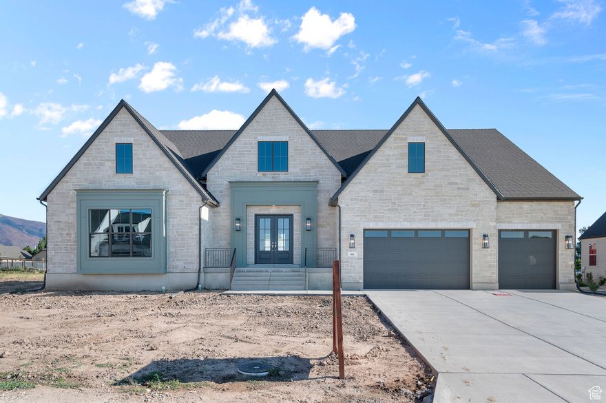 Experience refined living in a great Kaysville community! This beautiful Butler Traditional home is meticulously designed to fit the pickiest buyers needs!  As you walk into the entry and lead into the great room you will be impressed with the stunning coffered ceilings and size and space of the home. Also featured is a large chef's kitchen with custom cabinets highlighted with LED lighting, quartz countertops, gorgeous full height tile backsplash and stainless steel Caf gas appliances with double ovens anchored by pendant lighting above the kitchen island. Elegant laminate hardwood, tile, and carpet flooring flows through the home. The finished 3-car garage with exit door and finished game room in the basement with 9 foot foundation walls provides ample extra space. Other luxury upgrades include a water conditioner system, USB outlet in the owner's bedroom, gas line to the dryer, Christmas and flood light packages, while you can cozy up with gas log fireplaces in the great room, office, and owner's suite. The owner's bedroom shines with decorative ceiling beams, a ceiling fan, and an indulgent Tori tub in the spa-like bathroom featuring tile surrounds and polished nickel hardware. Accented with textured walls, 2-tone paint, Camden wainscoting in the office, and finished with Roosevelt base and casing, this home blends timeless charm with modern comfort. This home offers it all! Don't miss out!