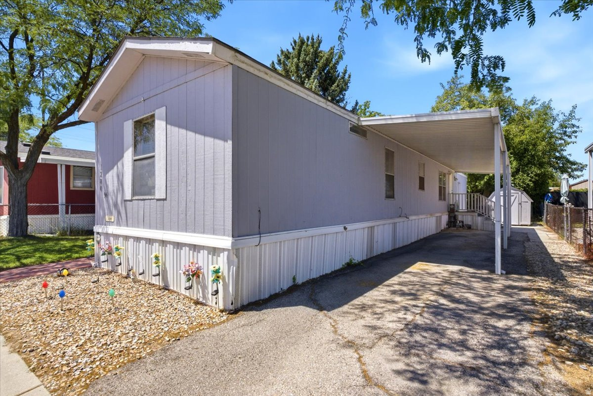 Single-story residence featuring light gray vertical siding and white trim