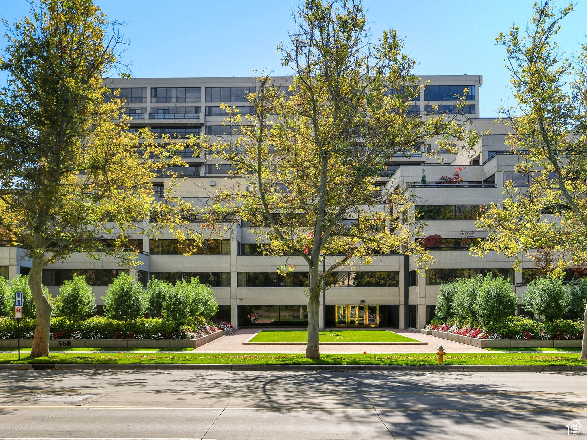 Discover the timeless appeal of Governors Plaza, known for its classic architecture, abundant amenities, & premier location along Salt Lake's prestigious South Temple. This spacious plaza-level residence offers nearly 2,000 sq. ft. of thoughtfully designed living space, complete with an office & 2 huge balconies unique to this level of the building. Expansive floor-to-ceiling, south-facing windows invite natural light & showcase serene, pine-filtered views year-round. The property serves as a remarkable canvas for a custom, luxury renovation & presents endless potential to craft an extraordinary living experience tailored to your vision. Residents enjoy resort-style amenities, including a heated indoor pool & spa, a bright and airy fitness center, a stunning atrium-style common area & community garden. The property also provides plenty of covered guest parking, along with two secured garage spaces, a 4'x8' storage locker, bicycle parking & a convenient car wash station.