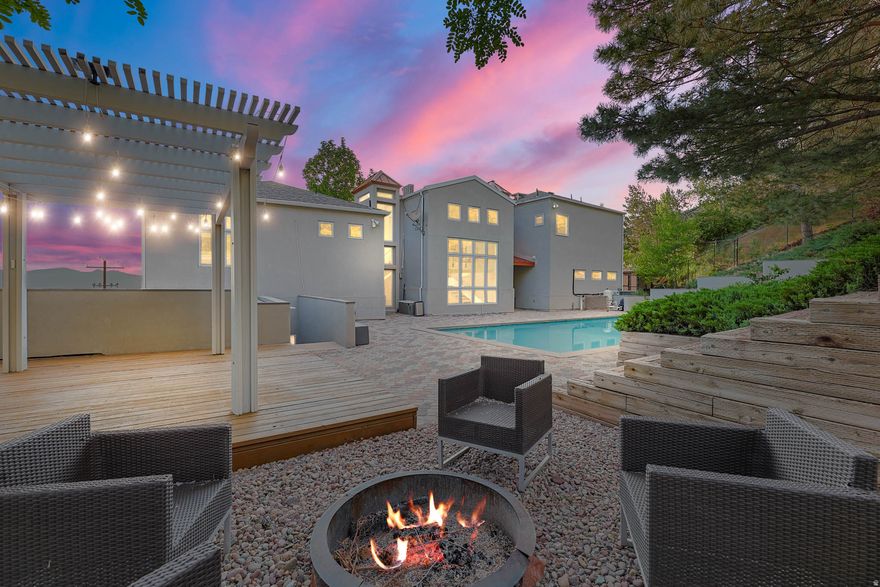 Don't miss the DRONE FOOTAGE in the TOURS section.  An iconic Arcadia Heights residence, this contemporary European 2-story blends unique European architecture with modern sophistication (over $734,000 in recent upgrades!). A stunning kitchen opens to elegant formal dining space with formal living room and wet bar just down the hall, all with impeccable views and rich tiger wood South American hardwood flooring!  The beautifully updated kitchen has views of the valley in front and expansive pool, fountain, and yard in the back! With heated floors throughout, it is perfect for gathering and entertaining. The oversized primary suite is a true retreat, featuring a spacious walk-in closet, a luxurious bath, and direct access to the private balcony overlooking the Salt Lake valley, covering a space for a hot tub and offering direct access to the 38ft x 17.5 ft saltwater pool. A fabulous sitting porch, just below the master deck and in front of the hot tub area also allows for unobstructed valley views. Rare for The Arcadia Heights neighborhood, the .52-acre lot offers valley views but no backyard neighbors, a private pool on the house main level, a firepit, gazebo, upper level patio, and direct access to Arcadia Heights trails out your backyard! All within minutes of Park City, multiple canyons, I-80 and I-215 freeways, SLC airport, shopping, dining, and the vibrant Salt Lake City lifestyle. This house is one-of-a-kind!!  Over $734,000 in recent upgrades! The updated German kitchen with Italian appliances and induction range is unlike any other! Enjoy the heated saltwater pool, (POOL SIZE 38 FT x 17.5 foot 34,000 gallons). Check out the custom updated bathrooms as well as the tiger wood floors that will delight the most discriminating buyers. Incredible valley views and spectacular sunsets await! Private deck off the master!  Central air, 6 mini splits, and radiant flooring throughout for optimum temperature control and comfort. Covered deck, and large patio! Also wired for a hot tub. Walking trails are steps away, right outside the back gate is the Arcadia trail (part of the Bonneville Shoreline Trail System) Mature landscaping creates a very private setting. Call today for a private showing! SEE THE ATTACHMENTS SECTION FOR A LIST OF ALL THE UPDATES AND IMPROVEMENTS!