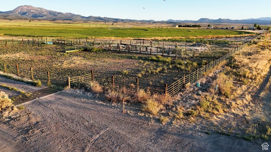 This 38-acre parcel in Garfield County, Utah offers flat, buildable terrain with paved frontage along Highway 89, granting efficient access and visibility. Utilities and water are nearby, and the property currently supports an agricultural operation with an in-place irrigation pivot from the West Panguitch Irrigation & Reservoir Company, fenced perimeters, stock corrals, and feeders. The soils have a record of agricultural productivity. The land gently slopes to the east, providing views of the adjacent river-bottom valley and open skies to the surrounding mountains. Its buildability and proximity to Panguitch-where services, gas stations, and a regional airport are minutes away-support a range of potential uses, including residential development, agricultural pursuits, or a commercial base. In a county where private land accounts for only 5 %, this flat, utility-equipped parcel is a rare offering. Recreationally, the location is strong. It is a short drive to Dixie National Forest and is centrally positioned as a gateway to several major destinations. Bryce Canyon National Park lies approximately 24 miles southeast. Zion National Park is approximately 67 miles south. In addition, Brian Head and Eagle Point ski areas and many other outdoor opportunities are within an easy drive, enhancing its appeal to users seeking access to tourism, lodging, or recreational development. Given the flat topography, access to infrastructure, agricultural suitability, and limited comparable private land in the area, the parcel offers multiple pathways for development or passive holding value.