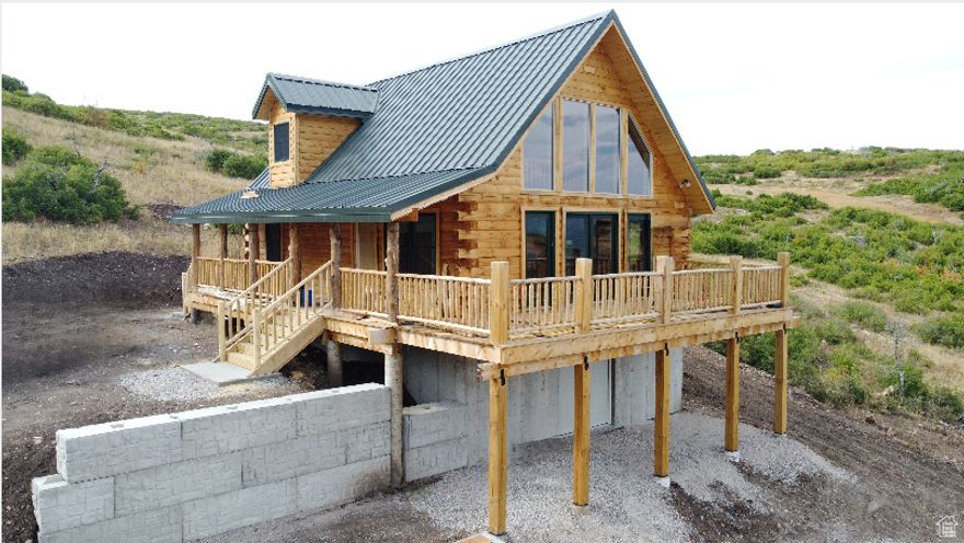 Stunning new 3-story log cabin with panoramic views, located in the peaceful Indian Ridge community in Indianola Valley-just under an hour from Provo. This beautifully crafted, off-grid cabin offers the perfect blend of comfort, seclusion, and year-round adventure. The main floor features two bedrooms, one full bathroom, and an open-concept kitchen and great room that opens onto a large wraparound deck on two sides-ideal for relaxing and enjoying the incredible views. Upstairs, you'll find a large open loft, perfect for additional living or sleeping space. The lower-level basement is already framed and ready for additional bedrooms and a bathroom. It also includes a double-door entry with a designated parking area for ATVs and snowmobiles, making it a great year-round retreat. For video of this beautiful cabin, check out the following link.   https://youtu.be/3huSs1B0JXw  This is true off-grid living, with water provided by Indian Ridge's private water company, a 1,000 gallon water storage tank, propane for gas, a septic system, and a generator for power. Winter access (typically December through April) is available by tracked vehicles only. A solar system could be installed for an additional $40,000. The property includes two adjacent lots: Lot Q-20 (1.03 acres) and Lot Q-21 (1.10 acres), Sanpete County Tax ID numbers 55367 and 55368.