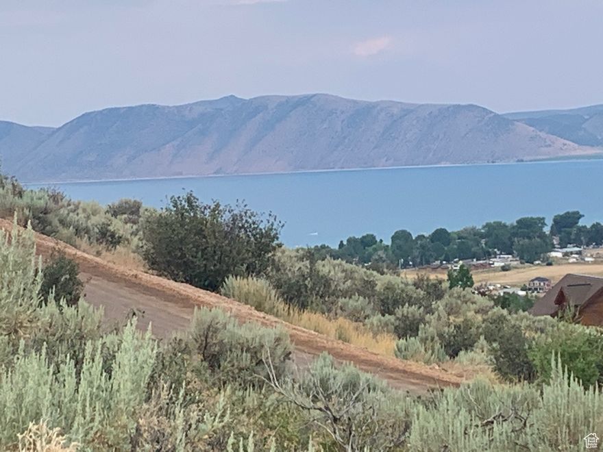 PRICE DROP!!  BEAR LAKE VIEWS  from this building lot in Sweetwater with year round access plus access to Hodges Canyon trailhead for UTV/ATV, snowmobiling trail system.  Optional amenities available (additional fee) at Ideal Beach Resort with two pools and hot tubs, huge lawn area, sports courts, mini golf, playground, GREAT BEACH with boat rentals. Bear Lake golf course 2 min; State Park marina 5 min; Beaver Mtn Ski Resort 20 min. Short term rentals not allowed.
