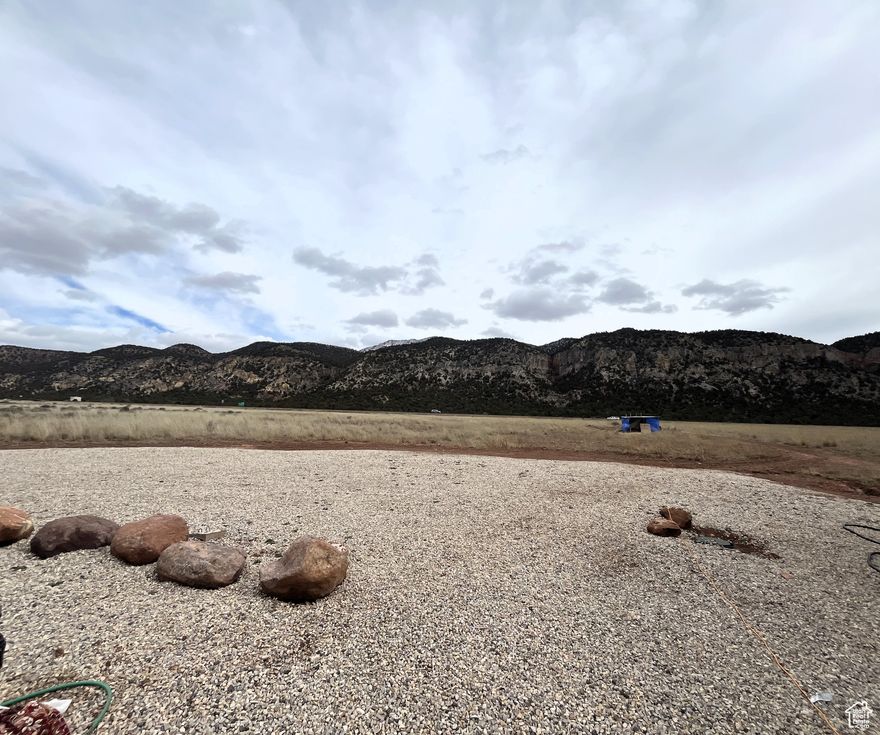 Don't miss this rare opportunity to own 5.32 acres with sweeping views in every direction! This versatile property comes ready with power, water, and septic connections for up to three travel homes, making it ideal for a variety of uses. A spacious shed is included, already tied into utilities, and currently serves as storage, laundry, and office space. With room to spread out and stunning scenery all around, this property is perfect for creating your own private getaway. Note: Trailers and shipping containers shown in photos are NOT included in the sale.