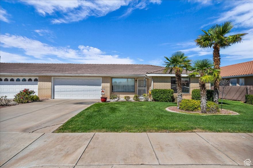 Well maintained all brick townhome located in 55+ community of Palm Meadows. The open concept design features a modern kitchen with granite countertops, moveable island and added oak cabinets and drawers for extra storage. Primary suite offers an ensuite bath with double sinks, tile shower and tile floors with additional custom cabinetry for added storage. Additional features include vaulted ceilings, LVP flooring, central vacuum, water softener and extra large capacity water heater. The backyard is a private retreat with low maintenance turf for year around enjoyment. A versatile enclosed patio room with insulated walls and abundant windows provides the perfect space for an art studio, office or den. The backyard also includes a large lifetime storage shed, while the two car garage is equipped with cabinetry on both sides for extra storage. Conveniently located just a few blocks from Utah Tech University, Intermountain Hospital, grocery store, shops, restaurants. Homeowners enjoy a private year-round indoor pool and spa. Swimming and hot tub are located just a few yards from the home's custom iron back gate.