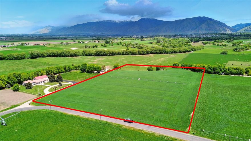 Rare opportunity to own 32 acres with direct Bear River frontage, panoramic views of the Wellsville Mountains, and endless potential. This private, serene property offers a mix of open land and mature trees, perfect for building your dream home, recreational use, or small development. Enjoy fishing, farming, and wildlife watching right from your own land. Convenient location with easy access to town. A true slice of paradise with investment potential. Includes 2 parcels (10-010-0010 & 10-017-0006) 15 Water shares in the Mendon-Wellsville Canal and water rights from other sources. Click tour button for video tour of the property.