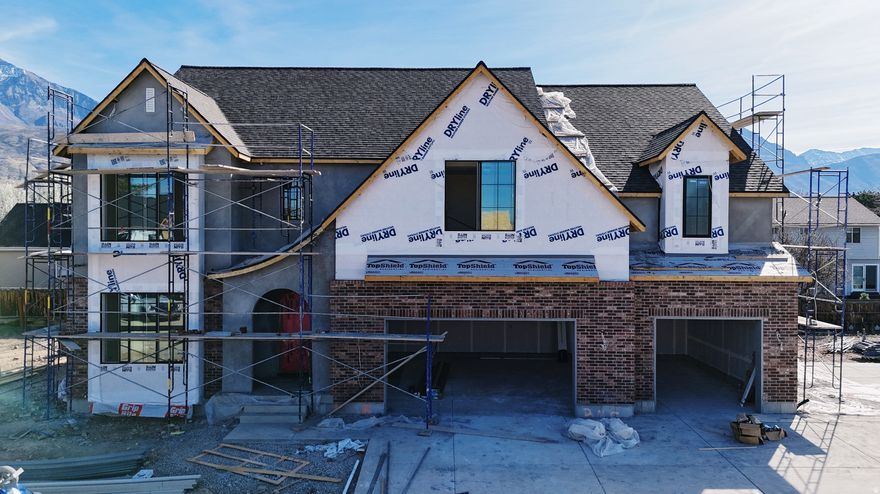 Our newest Neighborhood in Orem, Belmont West with the Avery Floorplan.  This stunning Tudor two-story home features a breathtaking two-story family room with an abundance of windows, allowing you to bask in natural light and enjoy spectacular views. The home boasts a luxurious butler's pantry with custom cabinetry, a commercial gas range, and a built-in twin fridge/freezer combo-perfect for entertaining and everyday living .Quartz counter tops, with designer touches throughout and so much more.. Basement entrance for future ADU  and it is Scheduled for completion Mid May, this home is a must see!