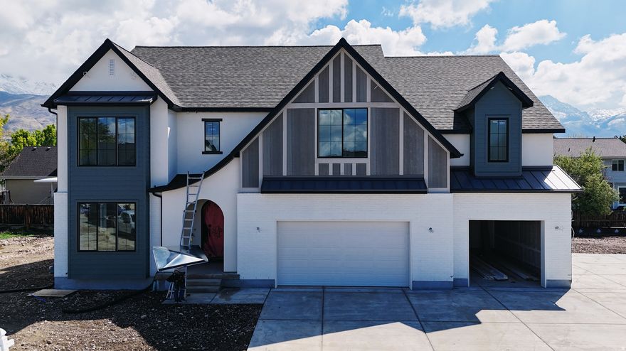 Our newest Neighborhood in Orem, Belmont West with the Avery Floorplan.  This stunning Tudor two-story home features a breathtaking two-story family room with an abundance of windows, allowing you to bask in natural light and enjoy spectacular views. The home boasts a luxurious butler's pantry with custom cabinetry, a commercial gas range, and a built-in twin fridge/freezer combo-perfect for entertaining and everyday living .Quartz counter tops, with designer touches throughout and so much more.. Basement entrance for future ADU  and it is Scheduled for completion Mid May, this home is a must see!