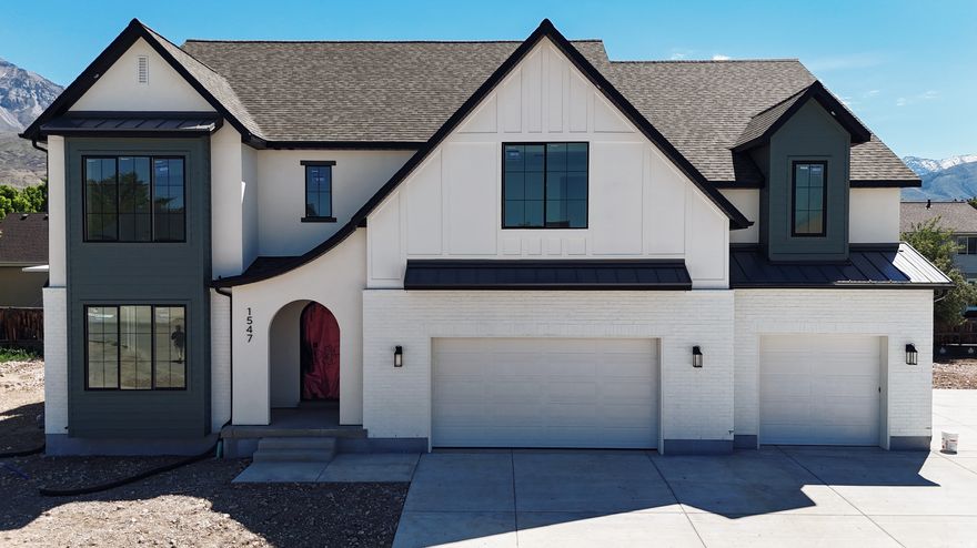 Our newest Neighborhood in Orem, Belmont West with the Avery Floorplan.  This stunning Tudor two-story home features a breathtaking two-story family room with an abundance of windows, allowing you to bask in natural light and enjoy spectacular views. The home boasts a luxurious butler's pantry with custom cabinetry, a commercial gas range, and a built-in twin fridge/freezer combo-perfect for entertaining and everyday living .Quartz counter tops, with designer touches throughout and so much more.. Basement entrance for future ADU  and it is Scheduled for completion Mid May, this home is a must see!