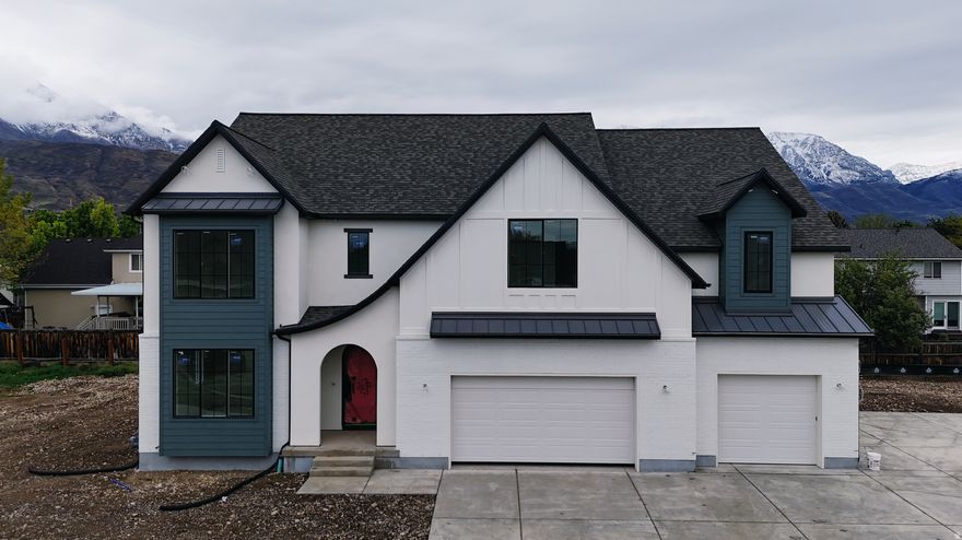Our newest Neighborhood in Orem, Belmont West with the Avery Floorplan.  This stunning Tudor two-story home features a breathtaking two-story family room with an abundance of windows, allowing you to bask in natural light and enjoy spectacular views. The home boasts a luxurious butler's pantry with custom cabinetry, a commercial gas range, and a built-in twin fridge/freezer combo-perfect for entertaining and everyday living .Quartz counter tops, with designer touches throughout and so much more.. Basement entrance for future ADU  and it is Scheduled for completion Mid May, this home is a must see!