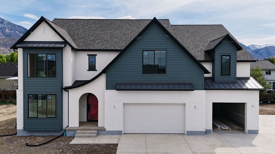 Our newest Neighborhood in Orem, Belmont West with the Avery Floorplan.  This stunning Tudor two-story home features a breathtaking two-story family room with an abundance of windows, allowing you to bask in natural light and enjoy spectacular views. The home boasts a luxurious butler's pantry with custom cabinetry, a commercial gas range, and a built-in twin fridge/freezer combo-perfect for entertaining and everyday living .Quartz counter tops, with designer touches throughout and so much more.. Basement entrance for future ADU  and it is Scheduled for completion Mid May, this home is a must see!