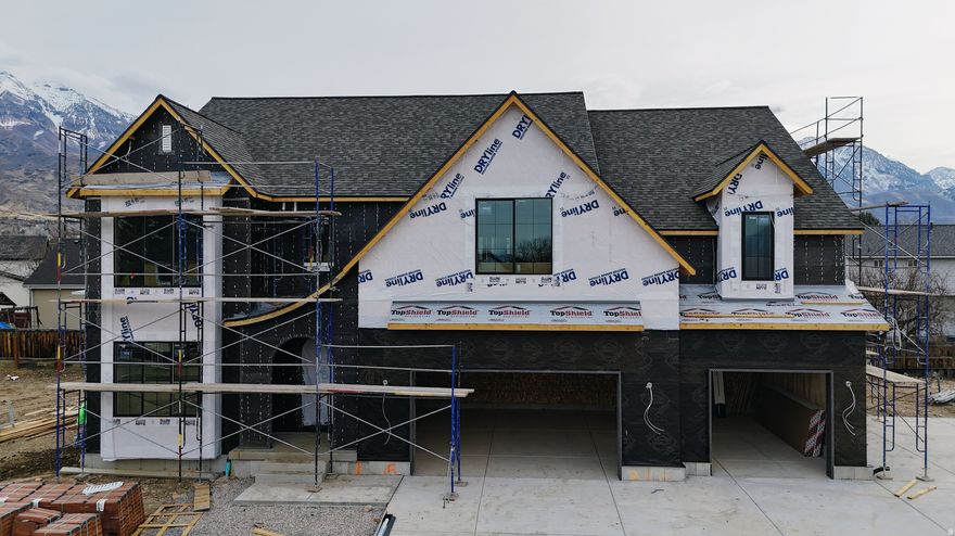 Our newest Neighborhood in Orem, Belmont West with the Avery Floorplan.  This stunning Tudor two-story home features a breathtaking two-story family room with an abundance of windows, allowing you to bask in natural light and enjoy spectacular views. The home boasts a luxurious butler's pantry with custom cabinetry, a commercial gas range, and a built-in twin fridge/freezer combo-perfect for entertaining and everyday living .Quartz counter tops, with designer touches throughout and so much more.. Basement entrance for future ADU  and it is Scheduled for completion Mid May, this home is a must see!