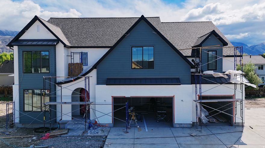 Our newest Neighborhood in Orem, Belmont West with the Avery Floorplan.  This stunning Tudor two-story home features a breathtaking two-story family room with an abundance of windows, allowing you to bask in natural light and enjoy spectacular views. The home boasts a luxurious butler's pantry with custom cabinetry, a commercial gas range, and a built-in twin fridge/freezer combo-perfect for entertaining and everyday living .Quartz counter tops, with designer touches throughout and so much more.. Basement entrance for future ADU  and it is Scheduled for completion Mid May, this home is a must see!