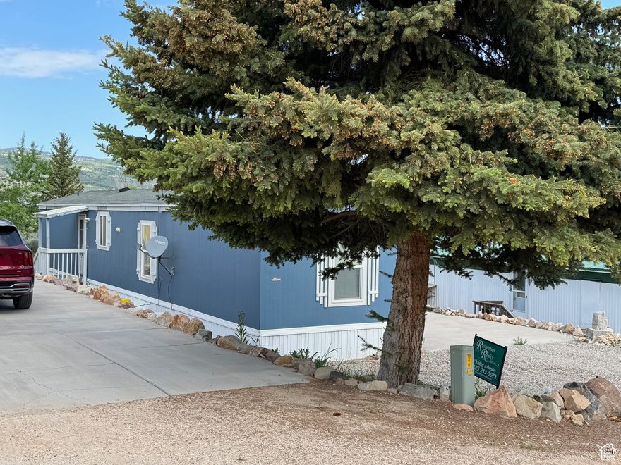 Completely remodeled with new kitchen cabinets, countertops, appliances, new vinyl flooring throughout, new bathroom tubs and toilets. Efficient/attractive propane stove/fireplace in living room heats home, with cadet heaters in bathrooms for extra comfort. Comes furnished. Year-round living in this darling updated mobile home with new exterior paint. Lot backs up to common area which expands the back yard - completely landscaped! At the back of the lot in the common area, add table and chairs to relax in the shade of Aspens and enjoy the lovely lake view. Enjoy the park's pool, basketball, volleyball courts, pavilion, grassy areas, and playground. Easy access to BEACH, MARINA, GOLF Course, Public Lands for ATV/snowmobile. Beaver Mtn SKI 25 minutes! Ideal place for a full time residence or a vacation home.