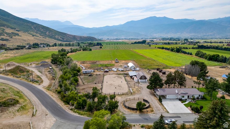 Incredible opportunity to own a piece of private paradise! Tucked away at the end of Big Hollow Rd this 10 acre dream awaits. Greenbelt taxation, water shares & wheel lines. Set up for horses, with 24' X 40' barn, 24' X 35' covered hay storage, paddocks & round pen.  Currently raising grass hay with an abundance of fruit trees and hoop/green house with garden area. Fully remodeled with tasteful finishes throughout including large kitchen with oversized island, stainless appliances & walk in butler pantry. Sun room off the kitchen offers great flex space for an office/den/mudroom/playroom. Main level living with 7 bedrooms, 4 bathrooms including a primary suite with dual vanities, walk in shower and walk in closet. Fully finished basement with large family room and fireplace. Potential to subdivide into two 5 acre lots opens up many possibilities, buyer to verify and comply with Daniel Town zoning codes. Located just below Wasatch Wild Life Management lands, ride your horses or toys directly from your property! Country living with easy access to Heber City's many amenities. Quick access to HWY 189 to Provo and HWY 40 to Strawberry Reservoir. Buyer to verify all.