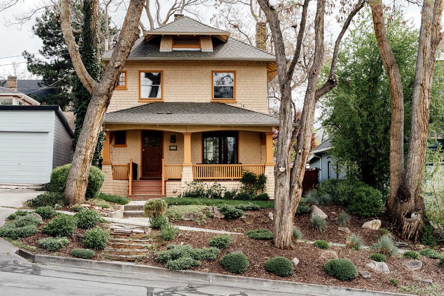 Built in 1908, this two-story home in the Avenues is a timeless example of classic Craftsman architecture. A wood exterior, wood-cased windows and doors, a handsome fireplace, and a covered front porch showcase its thoughtful detail and undeniable curb appeal.    Inside, the kitchen features cherrywood cabinetry, granite countertops, and stainless steel appliances. All three bedrooms are located upstairs, while in the lower level you'll find the laundry and plenty of storage.   Recent updates include a new main-floor bathroom, central air conditioning, updated basement flooring, a new water heater, and a reverse osmosis filtration system.   The grounds are truly exceptional. A xeriscaped front yard bursts with drought-tolerant plants, while the backyard offers mature, forty-foot trees, a gazebo, garden, and a spacious patio from which to take it all in.    The owners have cherished this home and its close proximity to local shops and parks-and now it's ready for new owners to fall in love with this classic Craftsman and the vibrant, eclectic neighborhood it calls home.