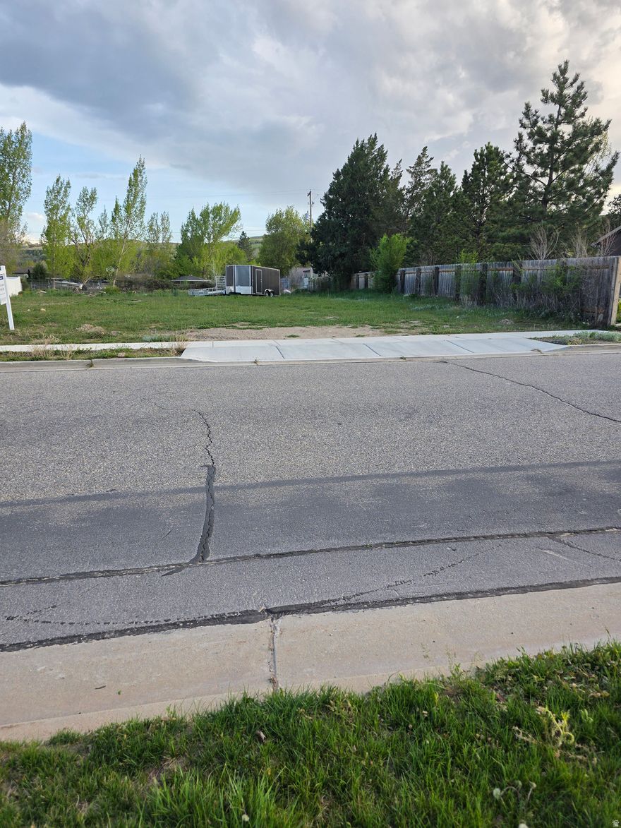 Opportunities like this don't come around often and when they do, I take them personally, because I know what they can mean for you and your future. This .31-acre lot in South Weber is one of those rare finds that just feels right the moment you stand on it. I'm talking about wide-open space, fresh air, and those breathtaking, unobstructed views of Ben Lomond Peak and the surrounding mountains views you can count on waking up to every single day. What I really love about this property is that it's truly ready for you. This property is all about space, views, and possibility. If you've been looking for a peaceful setting where you can build something special and enjoy the beauty of Northern Utah year-round, this might be the perfect place to start your next chapter. All the groundwork is already done culinary and secondary water, gas, power, sewer, curb and gutter, sidewalks, even partial fencing. That means you get to focus on the fun part... designing a home that fits you. And with the flexibility to bring your own builder, you're not boxed into someone else's vision you get to create your own. You'll also notice the pride of ownership all around you, with a newer home just next door and a community that's clearly cared for. Plus, you're perfectly positioned close to parks, and just a short drive to some of the best outdoor experiences Northern Utah has to offer, including skiing at Snowbasin and Powder Mountain, along with endless options for hiking, camping, and time on the water. For me and the owner, this isn't just a piece of land it's the beginning of something meaningful. A place where you can build, grow, and enjoy everything this area has to offer year-round.