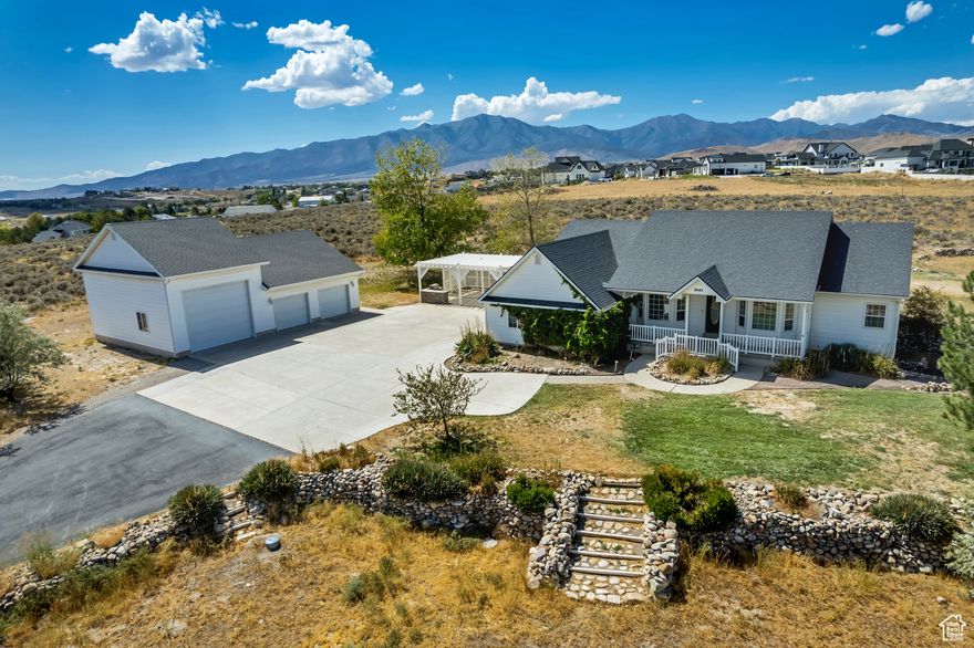 Plenty of  country living elbow room  with easy access to city living convenience. Beautiful views of Utah Lake Valley and the Mountains. Hydronic radiant floor heat, your own well (replaced in 2023), newer roof and natural gas to the house with a buried propane tank as well. Second 3 car garage (1400 sq foot) with a 14x18 bay, work space,1/2 bath and laundry is the perfect place for all your toys and projects. Beautiful gazebo with gas grill offers a great gathering space and plenty of privacy.  Seller financing would be considered  with 40-50% down and a 5 year balloon.