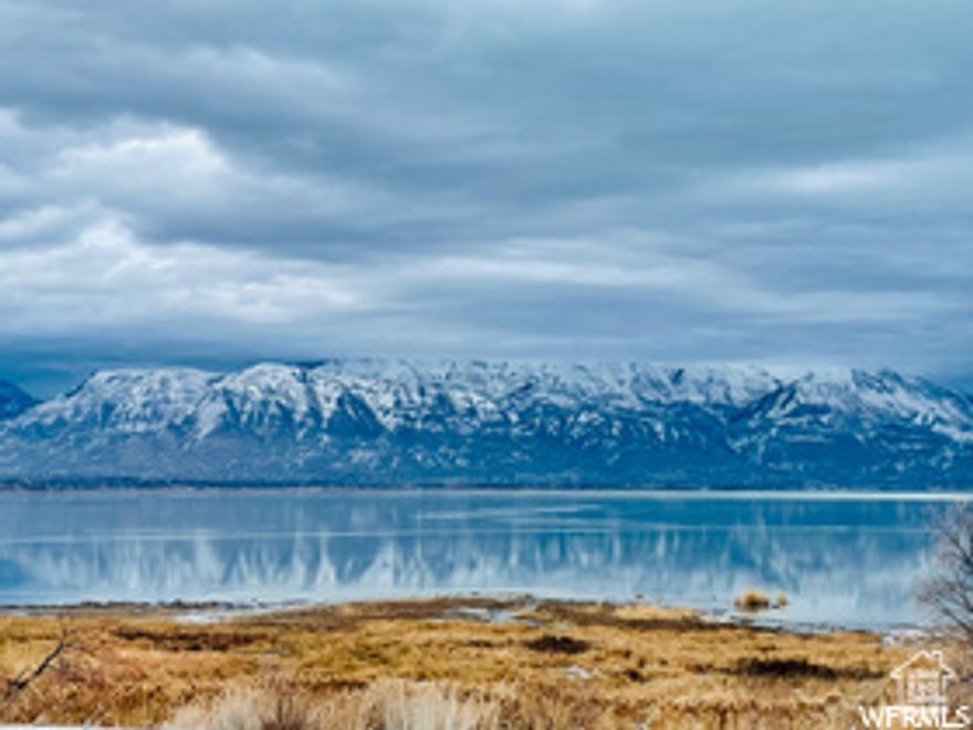 The owner believes this is the most beautiful lot for sale over looking Utah Lake. Breathtaking views of the Wasatch Mountains across the lake.  Kinda looks like being in Switzerland, with the lake and mountain views.  There is almost no opportunity to be able to buy a vacant lot on Utah Lake. Most of those lots are already built on. Nice thing about this lot is that on the south side the land belongs to Saratoga Springs, and it is a grassy area, well maintained, and it has a walking trail on it that goes down to the lake shore. This walking trail is suited for walks or bicycle rides along the lake shore. I am sure you will enjoy building a home on this lot and living with lake views. Call Mark the listing agent anytime to talk about viewing this lot and to negotiate buying this lot.  Lot size acreage figure is  provided as a courtesy estimate only and were obtained from __Utah County Land Records___ .  Buyer is advised to obtain an independent measurement.
