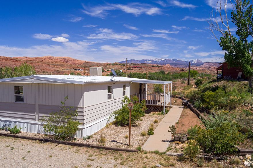 Welcome to your affordable retreat! The property will qualify for a conventional loan. Please contact listing agents for lender information. This cozy 2-bedroom, 1-bath home sits on a generous .53-acre lot, offering breathtaking views of the majestic La Sal Mountains. Perfectly positioned above the valley floor, this property provides a serene escape with two covered decks where you can relax and soak in the picturesque surroundings. Step inside to discover a welcoming atmosphere featuring a nice kitchen equipped with ample cupboard space and a gas range. This home is also set up for a pellet stove, ensuring warmth and comfort during the colder months. A sturdy shed provides space for your tools and outdoor gear. The property has the potential to build another home while utilizing the existing residence as an Accessory Dwelling Unit (ADU). Don't miss the opportunity to make this property your own, whether you're looking for a primary residence, a vacation getaway, or an investment opportunity.  Square footage figures are provided as a courtesy estimate only and were obtained from county records.  Buyer is advised to obtain an independent measurement.