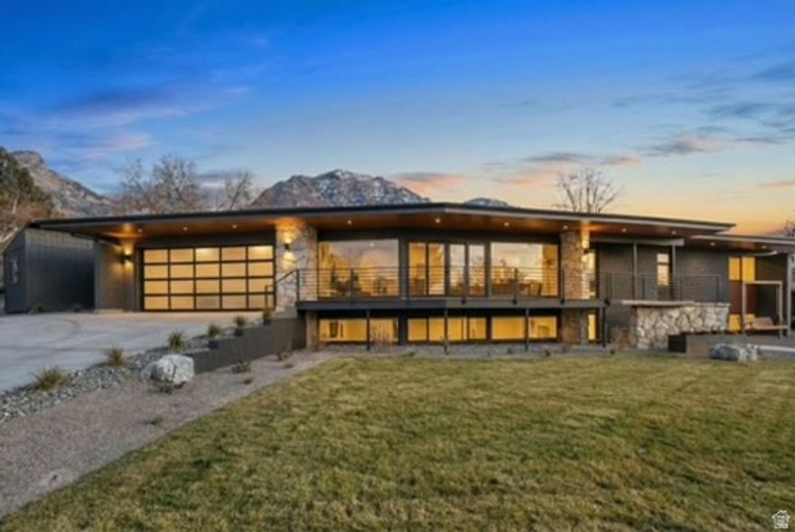 This legal ADU home can be used entirely as one residence or separately for added flexibility. Fully remodeled with a new roof, windows, landscaping, drywall, lighting, tile, bathrooms, and LVP flooring throughout. Mid-century modern design with bright open floor plans, closet organizers, and a designer kitchen featuring Bosch appliances, gas stove, hidden pantry, and roller shades on all windows. The epoxy garage includes 220V for EV charging. Enjoy outdoor living with a new Trex deck, fire pit, exterior swings, and backyard wiring for bistro lighting. Walking distance to BYU-must see.