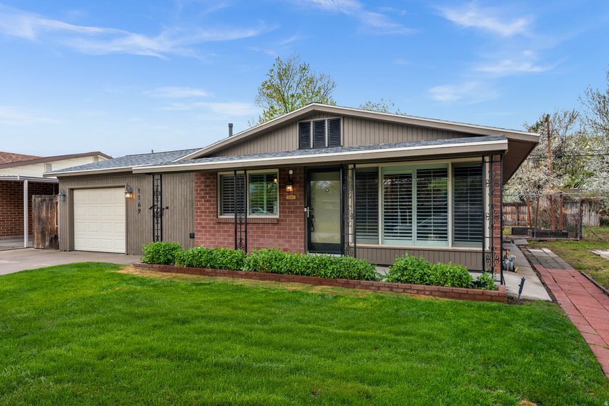 Enjoy the ease and comfort of single-level living in this charming brick rambler, ideally located in Salt Lake City. Designed with an open and efficient floor plan, this home offers 3 bedrooms plus a versatile bonus room-perfect as a potential 4th bedroom, home office, media room, or playroom.  The interior features updated windows, elegant plantation shutters, and beautiful hardwood floors. The bathrooms have been tastefully updated, and the layout provides both functionality and comfort. The large, open kitchen offers ample space for cooking and gathering, while the living room is enhanced by built-in bookshelves and great natural flow. Step outside to a private backyard designed for enjoyment, featuring a covered patio, mature rose bushes, and plenty of space for outdoor entertaining. The property also includes a large heated workshop, RV parking on the north side, and a single-car garage. Conveniently located just 2 minutes from I-15, this home offers excellent accessibility while maintaining a neighborhood feel. You'll appreciate being within walking distance to an elementary school, multiple parks-including a dog park-and the scenic Jordan River Parkway. Square footage figures are provided as a courtesy estimate only.  Buyer is advised to obtain an independent measurement.
