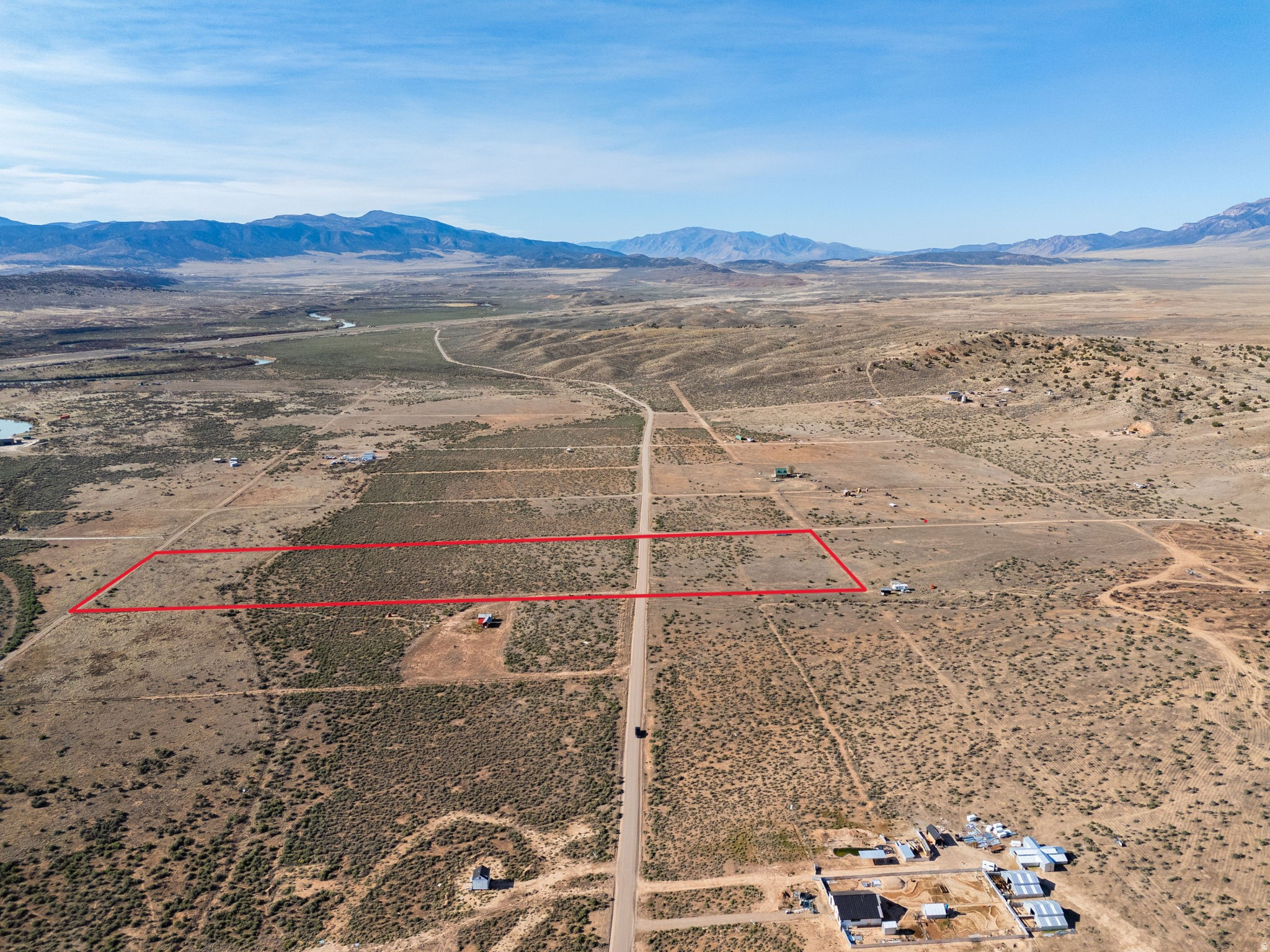 Expansive desert parcel outlined in red, featuring natural vegetation and flat terrain
