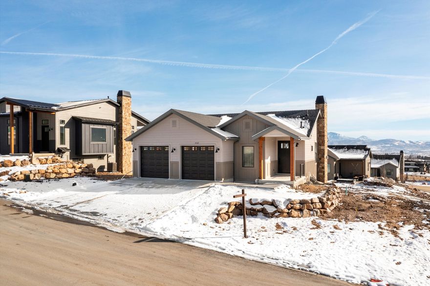 Beautiful Home in The Bridges at Wolf Creek  Minutes to Powder Mountain!! READY NOW! Experience the best of mountain living in this 4-bedroom, 3.5-bath residence located in the heart of Wolf Creek Resort. This 2,593 sq/ft home captures sweeping views of Mount Ogden, with a glimpse of Pineview Reservoir, and overlooks Nordic Valley, which lights up for night skiing in the winter months. The main level is designed for effortless living, featuring vaulted ceilings, a bright open kitchen, dining, and family room anchored by a gas fireplace, along with a main-level primary suite for added convenience. Step onto the sun-soaked deck to enjoy sunset views and the glow of the ski slopes after dark. The lower level offers additional living space with a second family room and an expansive bunk room designed for hosting guests, movie nights, gaming, or a versatile recreation lounge. Multiple patios and decks extend the living space outdoors, complemented by a 2-car garage with ample storage for all your mountain gear. The Bridges community provides maintenance-free landscaping so you can spend more time enjoying the valley and less time maintaining it.  Powder Mountain is less than ten minutes away, with Nordic Valley and Snowbasin also just a short drive. Pineview Reservoir offers boating, skiing, surfing, paddleboarding, and swimming, while the surrounding Wolf Creek area is filled with mountain biking, hiking, running, and Nordic trails. This home is the perfect year-round residence, second home, or vacation retreat in one of Utah's most desirable outdoor recreation corridors. Landscaping will be completed as weather permits.