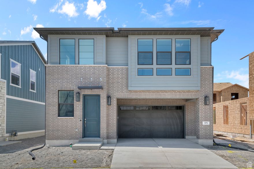 Come see this beautifully crafted Sundance Ballpark home in a great community! This home features an elegant kitchen with gray maple cabinetry, sleek quartz countertops, and premium stainless steel gas appliances. The interior boasts a tasteful mix of laminate hardwood, vinyl tile, and carpet flooring, creating a warm and inviting atmosphere throughout. Modern upgrades include can lighting, Christmas light outlets, a high-efficiency tankless water heater, and additional energy-efficient options designed to save you money and keep you comfortable year-round. With a stylish metal railing at the stairway, refined Craftsman base & casing, quartz shower surrounds in the owner's bathroom and brushed and satin nickel hardware this home blends timeless design with contemporary finishes. Comes fully landscaped that is maintained by the HOA for easy care living!