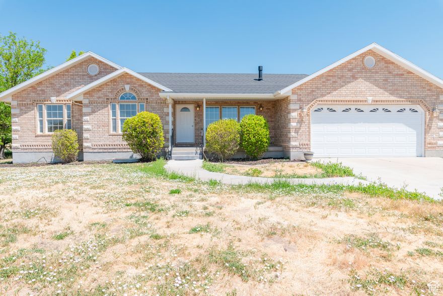 Enjoy the best of country living in this all-brick rambler on 5.91-acres just two blocks west of Nephi City limits. Recently updated with a new roof, furnace, a/c, carpet, paint and more  this 3,384 square-foot home is move-in ready!  The main level of the home boasts a vaulted great room/dining/kitchen area, fireplace, three bedrooms, 2.5 baths, large laundry room and numerous storage options. And the unfinished basement offers a blank canvas for the new owner. Soak up peaceful sunrises and sunsets from the shaded front porch and covered back patio.  The home comes with a well that provides water for the family home and the .91-acre parcel it sits on, and 4.5 water shares from the Nephi Irrigation Company that service the 5-acre agricultural parcel that's complete with corral and several out buildings. Alfalfa was the main crop and cattle the main industry of the farm in previous years.  Would also accommodate horses, pigs and chickens. Schedule your tour of this beautiful homestead today.  Note  the home needs a new sprinkler system; owner has received bids and is willing to credit buyer to have new system installed after settlement. *Measurements taken from County records; buyer advised to verify.