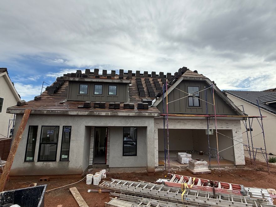 Custom builder, custom quality! Gorgeous craftsman-style home backing red rock open space-all natural backyard views you'll enjoy in large windows, a covered patio and private yard. Step inside and you'll find 9' ceilings, a separate dining room, flexible office/project/music room, and a spacious primary suite with its own laundry closet. Upstairs are three bedrooms w/walk-in closets, large family room, full laundry, tons of natural light, and mountain views. The kitchen is a showstopper with two-tone cabinetry, quartz countertops, wood-look LVP floors, and upgraded trims and finish. A handy mudroom with bench and coat closet greets you at the entry. The insulated garage includes sidelights and a side door.  Energy-efficient touches include zoned HVAC, R-50 ceiling insulation, CAT5 ethernet and coax pre-wiring, plus extra sound insulation in the primary bedroom. Gas/electric hookups for both the kitchen and laundry, second laundry hook-ups in primary bedroom closet. Even soffit outlets for outside holiday lights!  This home is loaded with extras from a builder who pays attention to every detail-you'll notice the difference. Call today for a private showing and see it in person.  Bonus: Preferred lender rate buydown may be available! Multiple programs could work for you-ask us for details.