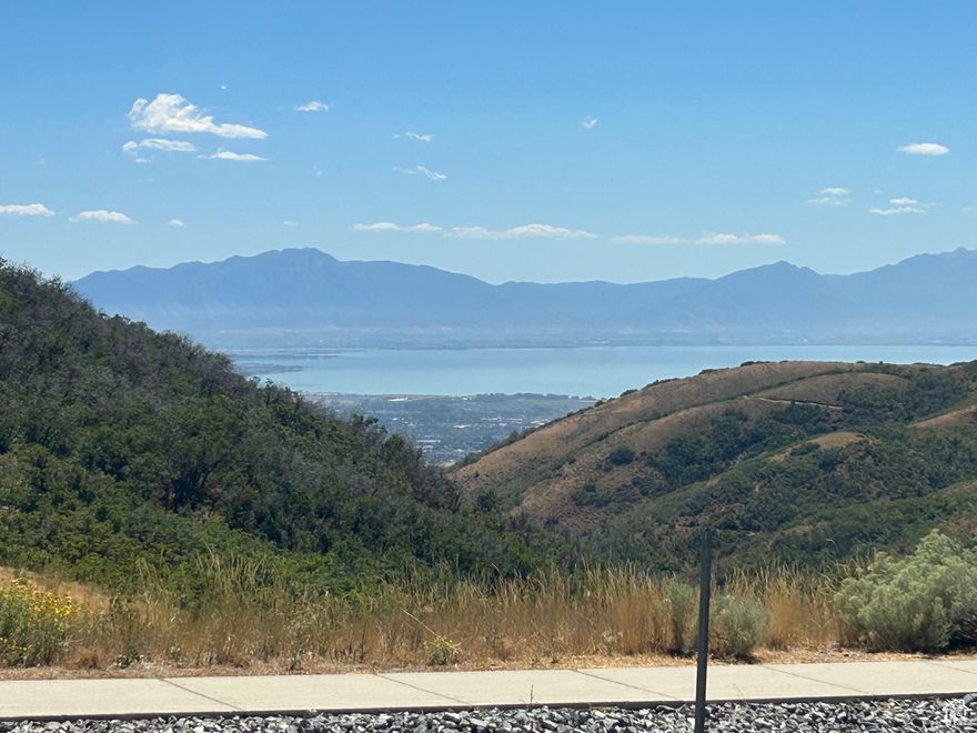 Discover an exceptional opportunity to build your dream home atop a scenic 0.63-acre lot in the coveted Deer Ridge neighborhood of Draper's SunCrest area. Perched above the Wasatch Front, this elevated homesite offers unobstructed panoramic views of Utah Valley, Utah Lake, and majestic mountain ranges-perfect for enjoying breathtaking sunrises, vibrant city lights, and tranquil evenings beneath the stars.  Elevated above the inversion for cleaner air and cooler summers, this lot is an outdoor lover's paradise-with trail access at your doorstep.